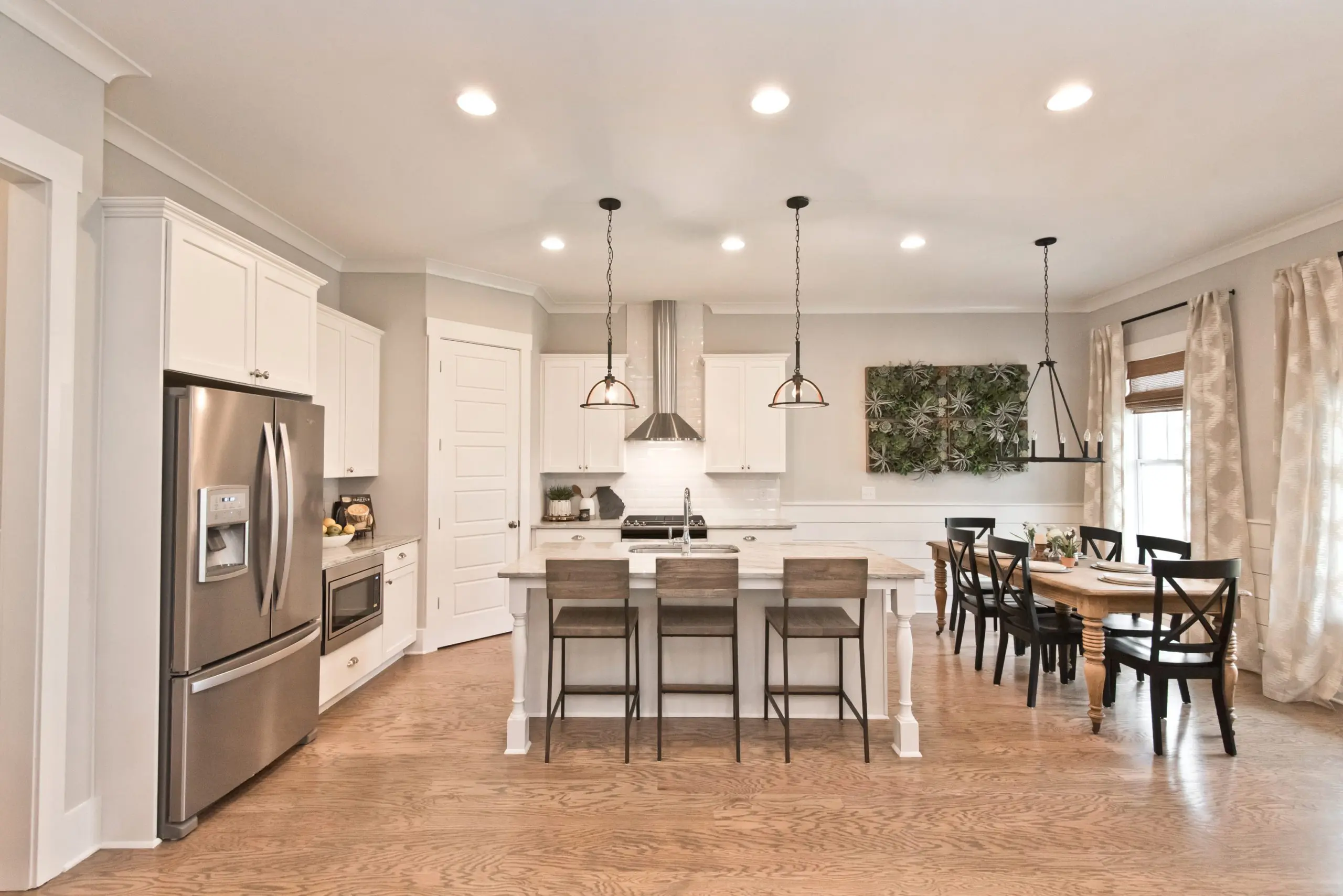 Open floor plan kitchen/ dining area in west highlands model home
