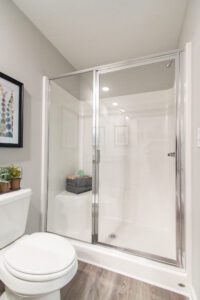 A glass shower with sitting area.
