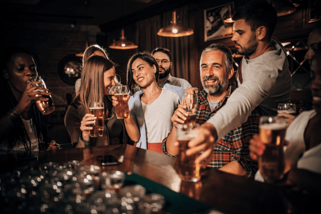 Group of smiling people drinking beers at one of the bars in Marietta